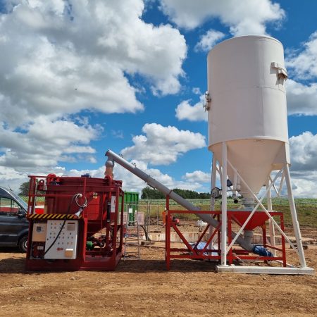 A silo pumping concrete onto a truck | Bentonite MS