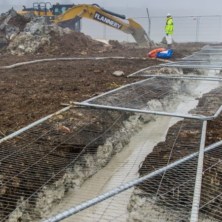 Digger in a muddy field creating a slurry wall | Bentonite MS